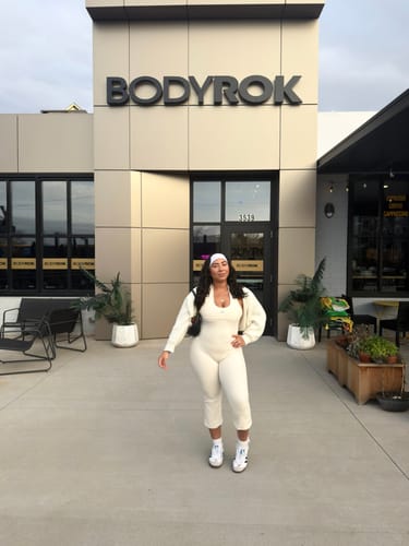 Reviewer posing in the cream Perfect Capri and matching top, facing the camera outdoors.