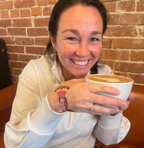 Reviewer at a coffee shop showing a fun custom birthday tattoo on their hand.