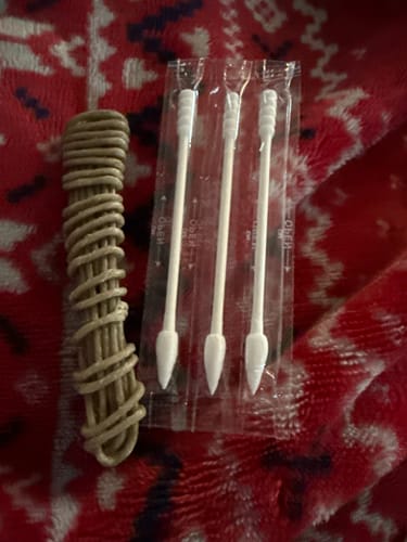 Customer's hemp wick and three cotton swabs from the Smoke Box kit on a blanket.