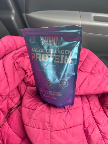 Reviewer's bag of Sunna Halal Collagen Protein resting on a pink puffer jacket.