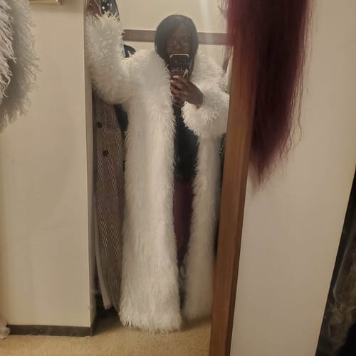 Reviewer taking a mirror selfie wearing the long, white Faux Fur Plush Long Coat.