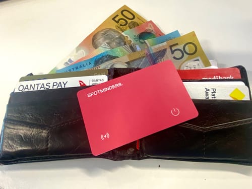 Customer's red SPOTMINDERS Tracking Card displayed in a black wallet with other cards and Australian currency.