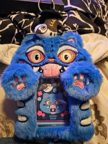 Customer's plush blue Derpy photocard holder, showing the attached Sussie charm and a card inside the window.