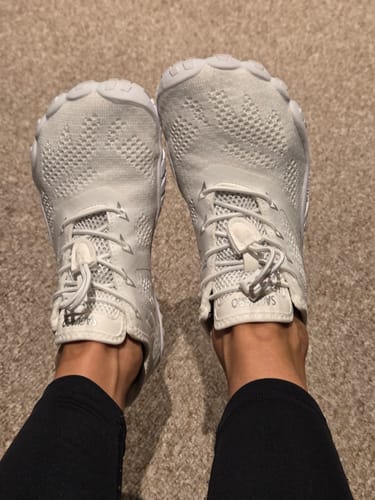 Reviewer's feet in white Smart Ⅰ - Barefoot Shoes, seen from above, showing the knit texture and wide toe box design.