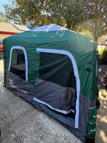 Customer's green and grey Large-Sized 2-Step Cabin Tent fully inflated and set up on a driveway.