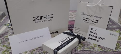 Customer's premium packaging for Bleu De Zing, including a white box, branded bags, and complimentary cards.