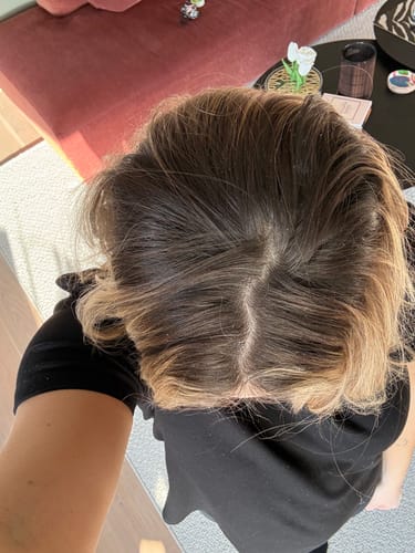 Customer shows their dark root regrowth before using the Sunkissed Starter Kit.