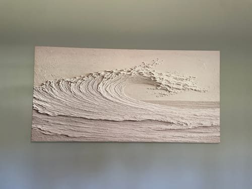 Reviewer's Minimalist Wall Art V, a textured piece depicting a large ocean wave, hanging on a plain wall.