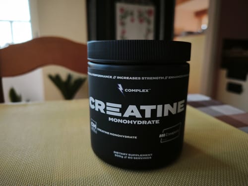 Customer's photo of a black tub of Complex Creatine Monohydrate on a table, submitted with a review for Sleep Magnesium.