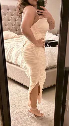 Customer's side view of the Kana Blush Pink Ruched Mesh Slit Dress, highlighting the fit and slit.