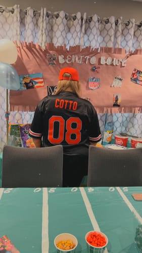 Reviewer from behind wearing the black Puerto Rico custom football jersey with the name "COTTO" and number "08" in red.