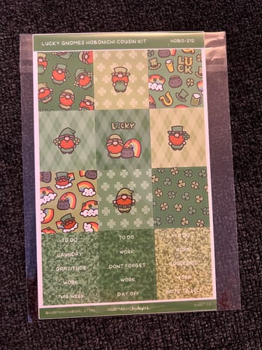 Customer's Lucky Gnomes Hobonichi sticker kit in its clear packaging. The sheet has cute green gnomes and shamrock designs.
