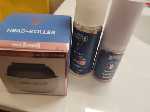Avis d'un client sur le Pack d’Odin : la boîte du Head-Roller, le sérum et le spray désinfectant sur une surface blanche.