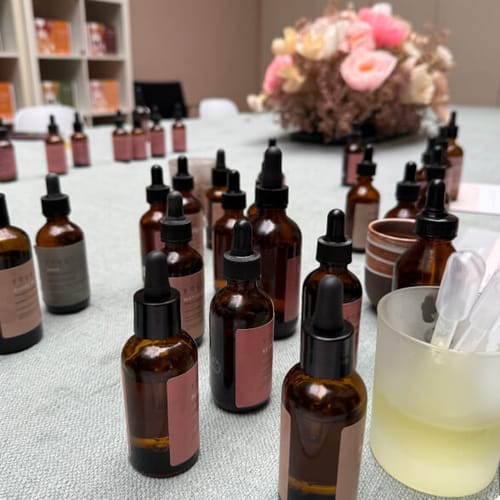 Customer's view of the Perfume Making Workshop, showing many amber dropper bottles of essential oils set up on a table.