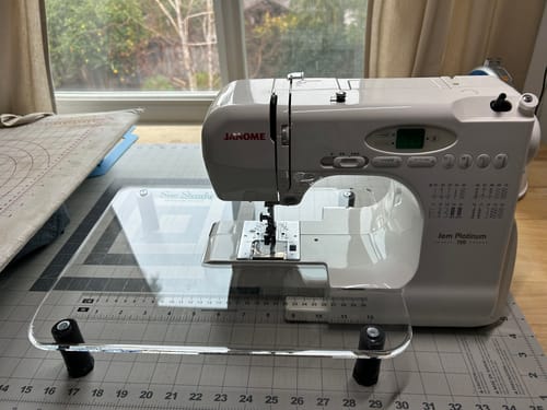 Customer's clear Sew Steady Extension Table fitted to a white Janome sewing machine on a desk.