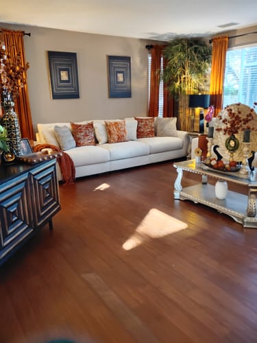 Customer's living room featuring two Black And Gold Core Wall Art pieces hanging above a long sofa.