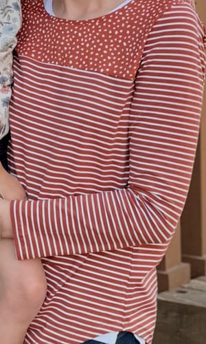 Customer wearing the Speckled Top Striped Long Sleeve, showing the contrasting speckled and striped patterns.