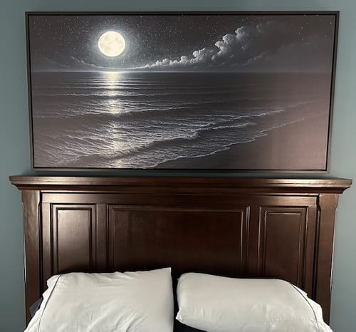 Customer's large Beach Shoreline Coastal Wall Art depicting a moonlit ocean, displayed above a dark wooden headboard.