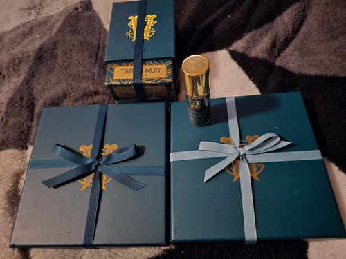 Customer's two Limited Edition Discovery Sets and a Tabac Nuit fragrance, all shown in their elegant blue gift packaging.