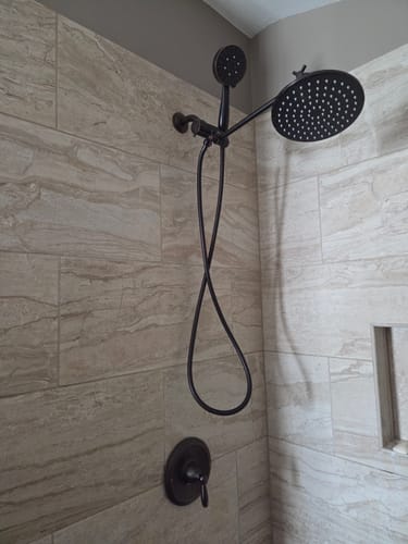 Customer's installed 1-Spray Dual Shower Head Set with a beautiful dark finish in a tiled shower.