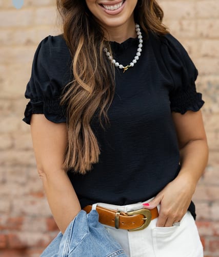 Reviewer wearing the black Cinched Neck Ruched Puff Sleeve Blouse, showing the puff sleeves and cinched neckline detail.