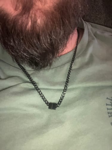 Customer's close-up of their black Legacy necklace, showing the single bead turned to a blank side.