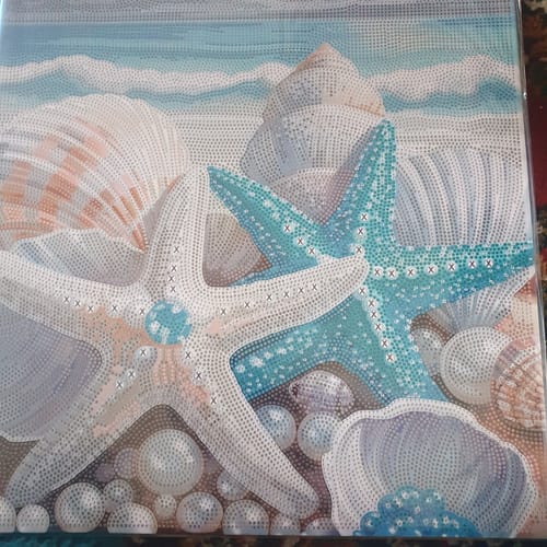 Reviewer's finished Seaside Treasures Crystal Art canvas, a vibrant beach scene with starfish and shells.