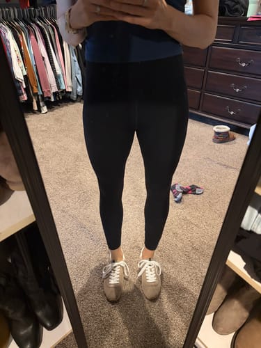 Customer wearing the beige suede PRISCILLA sneakers with black leggings, seen in a mirror.