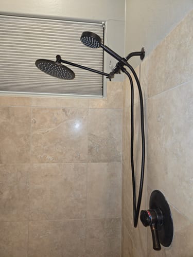 Customer's dark 1-Spray Dual Shower Head Set installed in a tiled shower, showing both heads.
