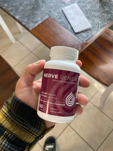 Customer holding the white and burgundy bottle of BioNerve+ Nerve Renew Complex.