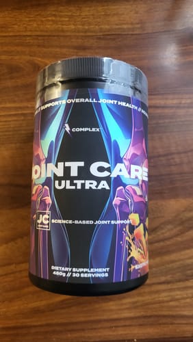 Customer's new, sealed tub of Joint Care Ultra supplement sitting on a wooden surface.
