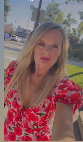 Reviewer takes a close-up selfie outdoors wearing the Your Peace Pink Floral Print Tiered Romper.