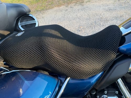 Customer's black mesh Wind Rider Seat Cover installed on a motorcycle seat, shown in a close-up view.