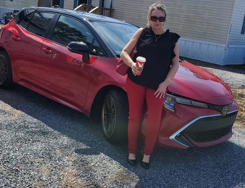 Reviewer standing outdoors in red Betsey's Jeggings and a black top.