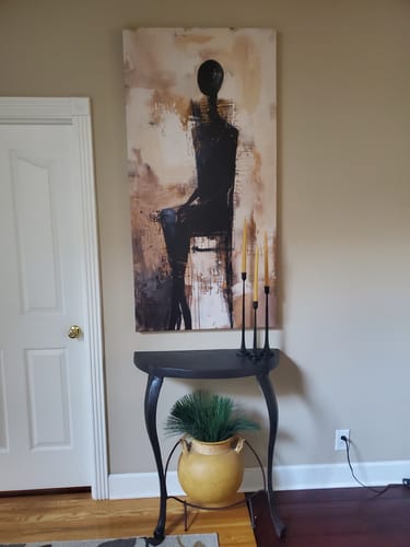 Customer's Waiting Figure Abstract Wall Art hanging vertically on a wall above a console table.