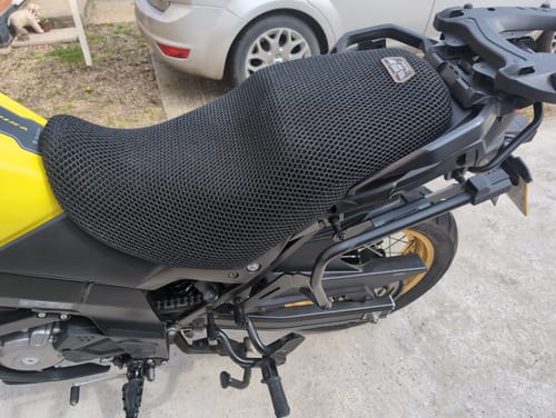 Customer's black mesh Wind Rider Seat Cover installed on the seat of a yellow motorcycle.