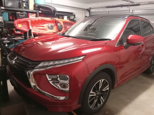 Customer's shiny red car parked in a garage, dried to a brilliant finish with the KoalaCloth.