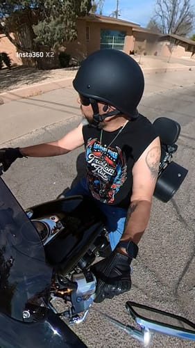 Customer on a motorcycle wearing the low-profile Polo Featherlight Flat Black helmet.