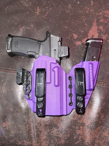 Reviewer's purple AXIS ELITE appendix carry holster holding a firearm and magazine.