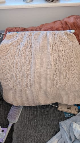 Customer showing the back of a cardigan being knitted using the Hayfield 10606 Bonus Aran pattern.