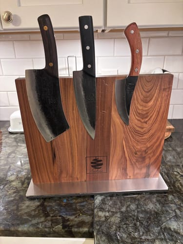 Customer's three kitchen knives displayed in a wooden magnetic knife block on a granite countertop.