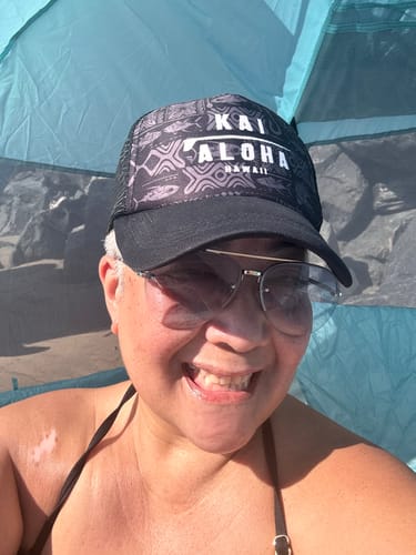 Close-up of a smiling reviewer showing their skin while trying the Body Magic Chlorophyll Pills.