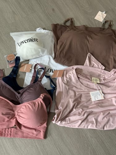 Customer's Lovemère haul showing several nursing bras and tops, with Mère Bottoms in their packaging.