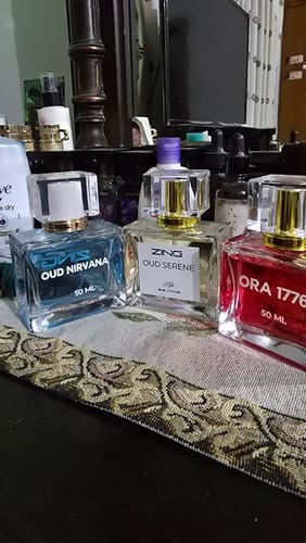 Customer's OUD Supreme BUNDLE, with bottles of Oud Nirvana, Oud Serene, and Ora 1776 on a dresser.