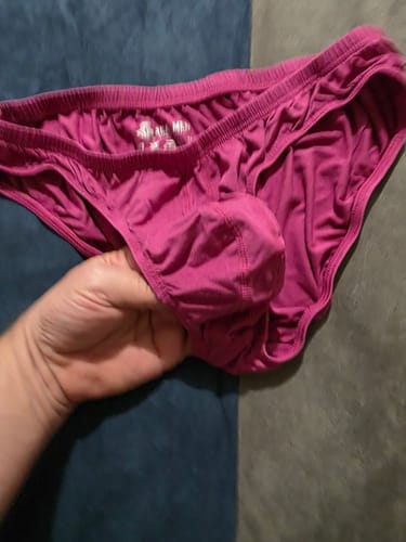 Reviewer holds up a pair of mulberry Modal Ares Ascent Low-Rise Bikini Briefs, showing the front pouch.