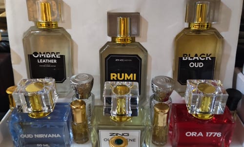 Customer's OUD Supreme Bundle, featuring Oud Nirvana, Ora 1776, and Oud Serene, displayed with other perfume bottles.