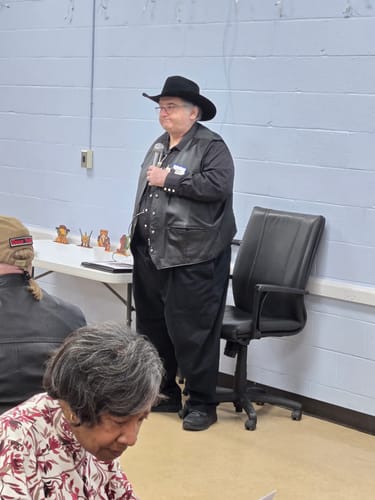 Reviewer, dressed as a Sheriff in a black cowboy hat, hosts the Wild West Cowboy Murder Mystery game.