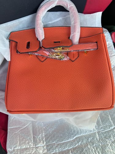 Customer's new orange Warkin Bag with pebbled leather, still in its protective wrapping.