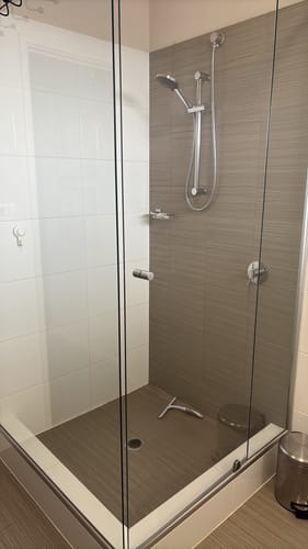 Reviewer's spotless glass shower enclosure after being cleaned with a KoalaCloth LITE.