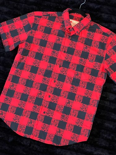 Reviewer's RSVLTS 'Lumberjack' short sleeve shirt laid flat, displaying its red and black checked pattern.